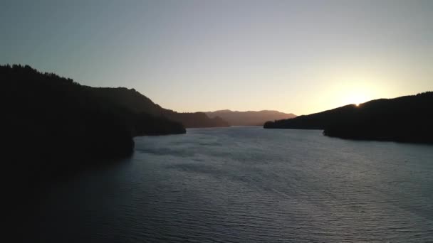 Birds-eye view of the sunrise over the river with hilly terrain. — Stock Video