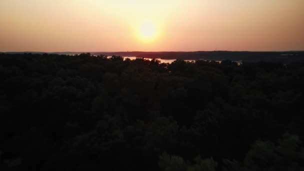 A shot of the sunset over the river taken from a drone. The drone flies over the vicinity of the river. — Stock Video