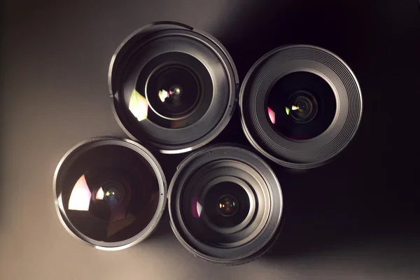 Set of DSLR lenses, different sizes and reflections. Cross processed. — Stock Photo, Image