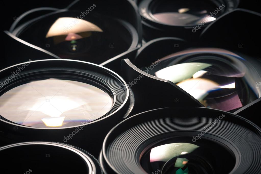 Set of DSLR lenses, different sizes and reflections. Side view. — Stock