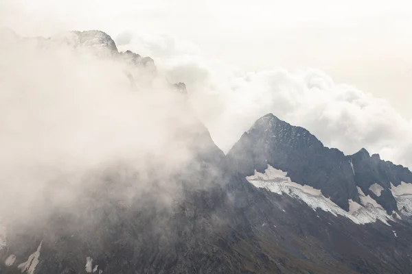 Snow capped mountain range in the clouds. Caucasus, Russia — Stock Photo, Image