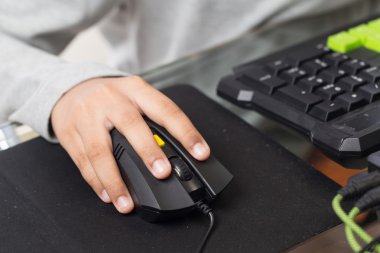 Close up on right hand for clicking over mouse by gamer kid (Sel clipart