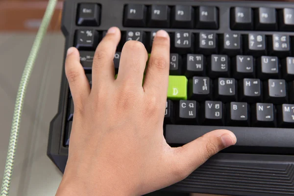 Asiatisches Kind linke Hand und mit dem Finger auf die Gaming-Tastatur drücken — Stockfoto