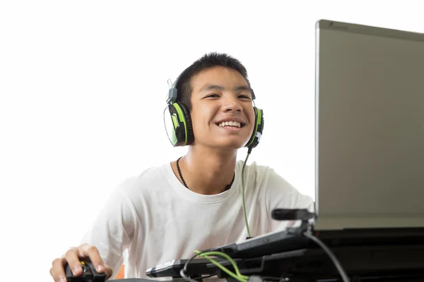 Aziatische tiener met behulp van computer en luisteren naar muziek met smily fac — Stockfoto