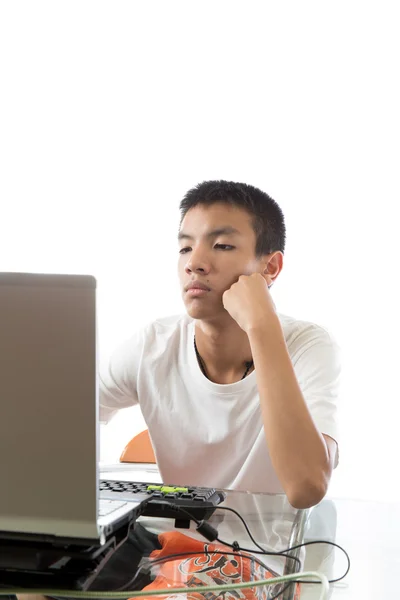Aasialainen teini tietokoneella — kuvapankkivalokuva