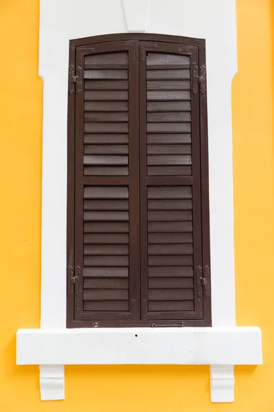 Antique style window on yellow wall — Stock Photo, Image