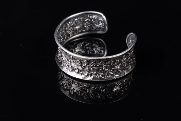 Old handmade Silver bracelet on black background — Stock Photo, Image