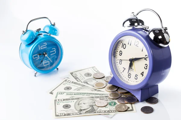 Two of old style alarm clocks on top of pile of banknote and coi — Stock Photo, Image