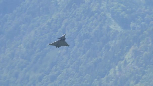 Figther jet flying at low speed and high angle of attack in an alpine valley — Stock Video