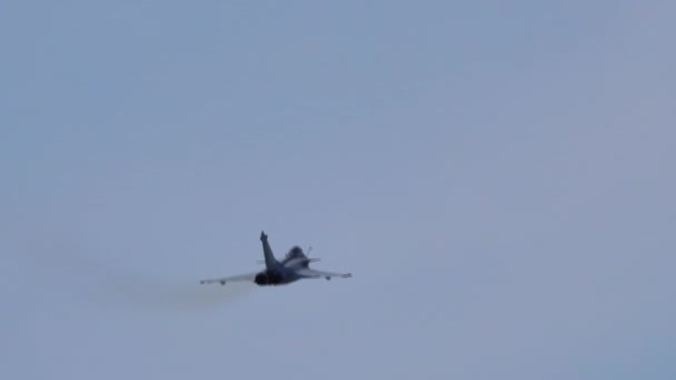 Fighter jet flygplan klättrar upp vertikalt i den blå himlen en solig dag — Stockvideo