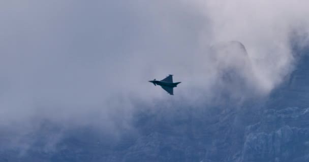 Σύγχρονο στρατιωτικό αεροσκάφος με φτερά δέλτα και πτερύγια καναρινιού σε πτήση στο βουνό — Αρχείο Βίντεο