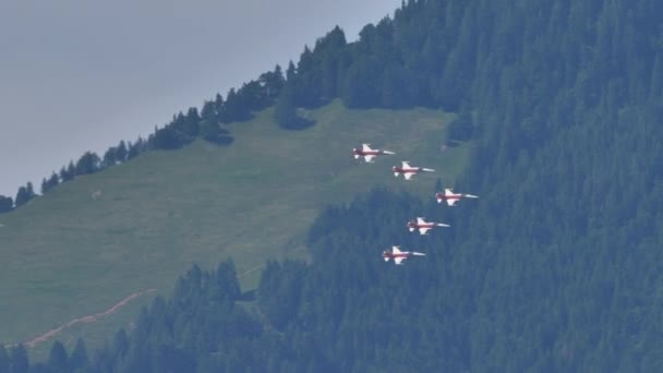 Samoloty wojskowe lecące w formacji strzałek blisko zielonej góry — Wideo stockowe