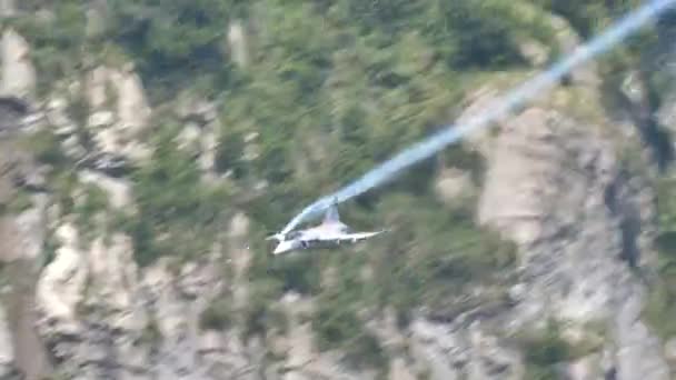 Einstrahliges Kampfflugzeug fliegt mit hoher Geschwindigkeit in der Nähe eines Berges — Stockvideo