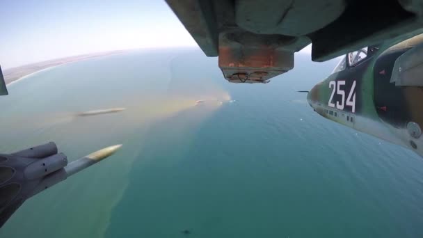 Military jet airplane fires a flurry of rockets filmed by a gopro under the wing — Stock Video