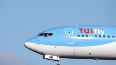 Boeing 737 800 'ün gövdesinde TUIfly logosu var. Mavi gökyüzünde uçan uçak