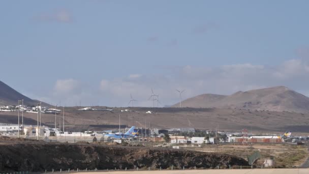 Wide view of Lanzarote airport with Wind turbines in the background — Stock Video