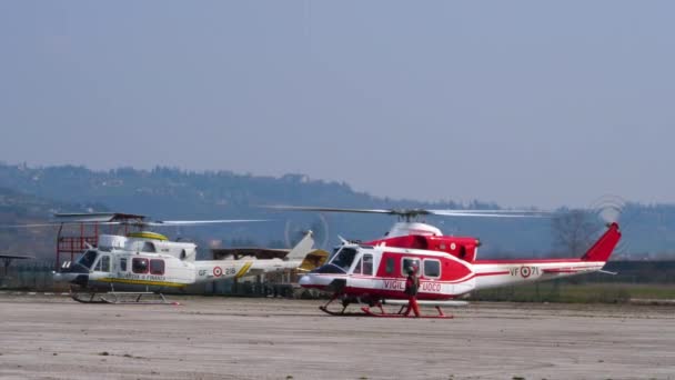 Brandweerman inspecteert helikopter voordat hij instapt in Agusta Bell AB-412 Grifone — Stockvideo