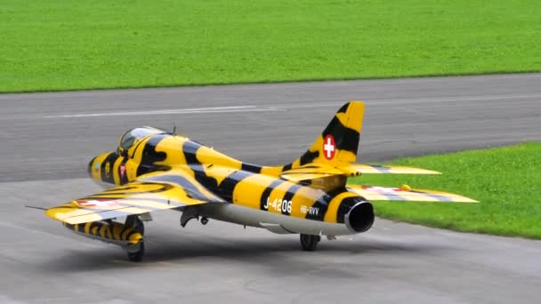 Cold War jet military plane with yellow and black livery taxies on the runway — Stock Video