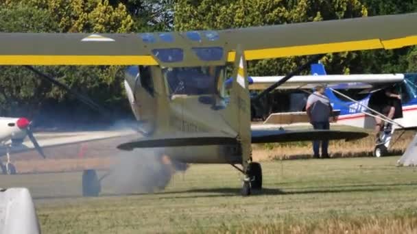 Vietnam War era military airplane taxis on grass runway with smoke — Stock Video