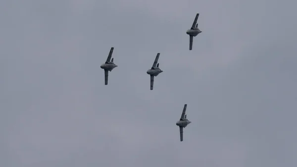 Cuatro aviones militares en vuelo en formación en el cielo nublado. Copiar espacio — Foto de Stock
