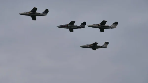 Four military airplanes in flight in formation in cloudy sky. Copy space — Stock Image Four military airplanes in flight in formation in cloudy sky. Copy space Stock Picture