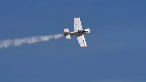 Perfil plano de un pequeño avión acrobático de hélice en el cielo perfectamente azul —  Fotos de Stock