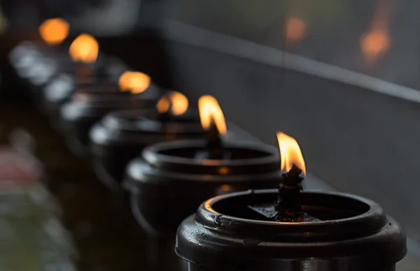 Lignting of Praying candles in a temple — Stock Photo, Image