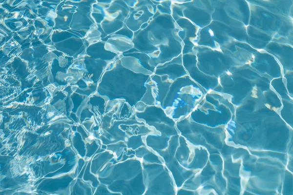 Zwembad water achtergrond met reflecties van de zon Stockfoto