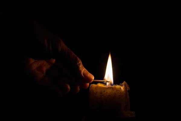 Men are using the match to light the candle — Stock Photo, Image