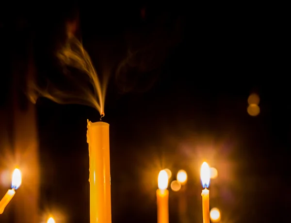 Yellow candle on the background and smoke — Stock Photo, Image