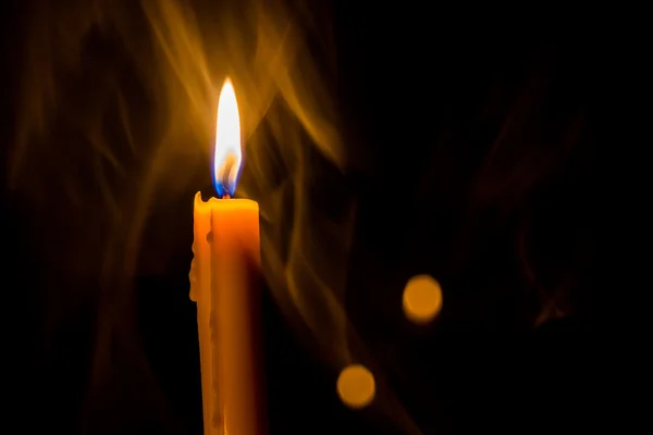 Yellow candle on the background and smoke — Stock Photo, Image