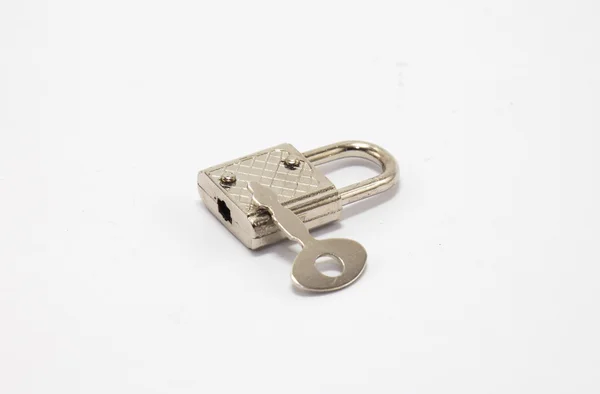 Padlock with key in white isolate — Stock Photo, Image