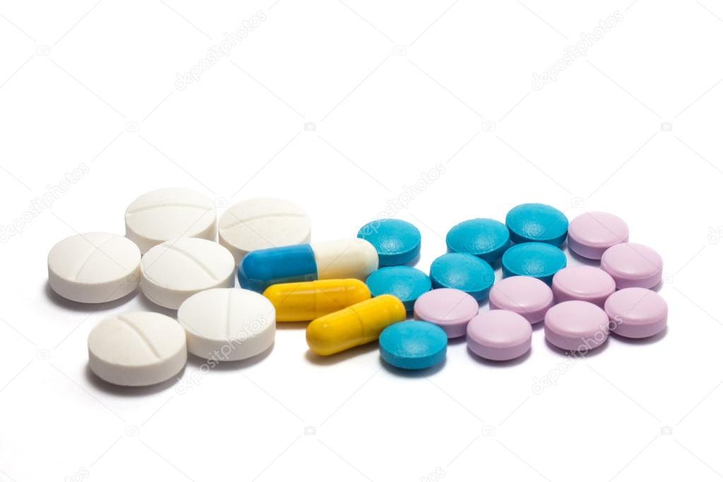 Diferent tablets pills heap mix on white isolated background