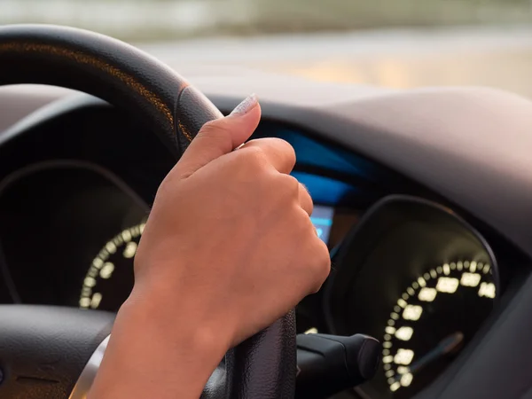 Girl one hand driving car showing meters — Stock Photo, Image