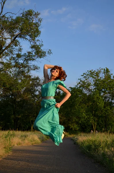 Chica en un vestido saltando — Foto de Stock