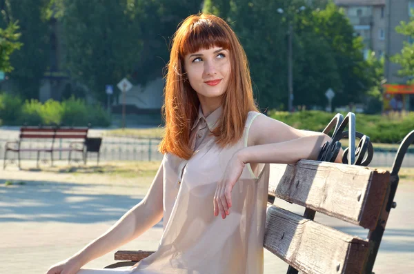 Meisje dromen zittend op een bankje — Stockfoto