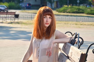 Red-haired girl with a sensual look