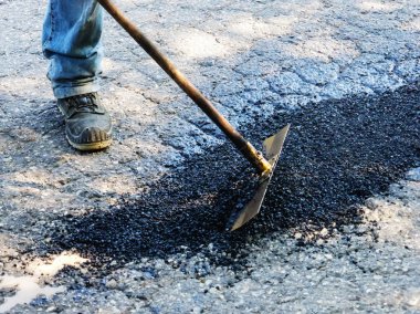 Closing potholes with asphalt clipart