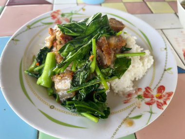 fried crispy pork with kale on hot rice