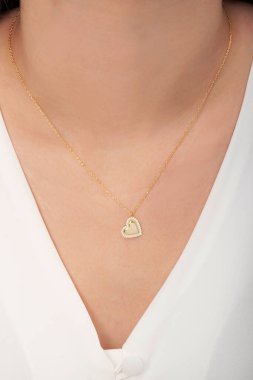 Tırnakları bakımlı olan bayan, çok güzel kolyeler veriyor. Gümüş, elmas, altın kolyeler.