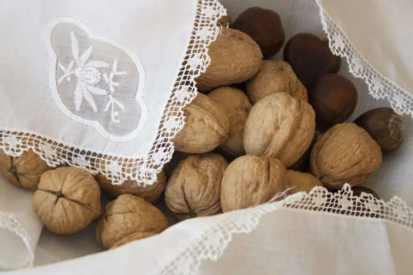 Walnuts and chestnuts in a basket — Stock Photo, Image