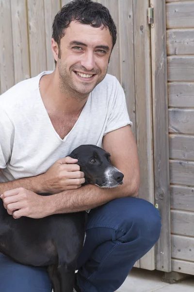 Çekici bir adam ile siyah köpek