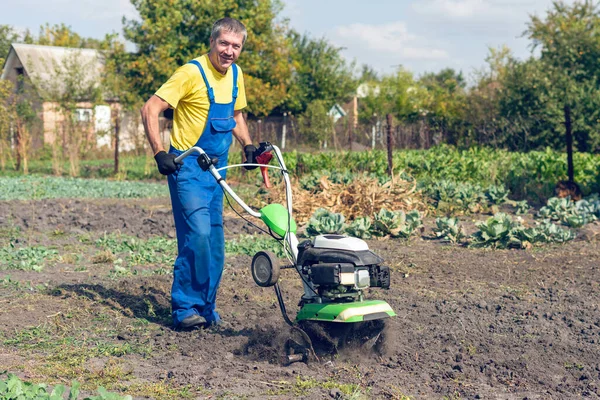 Der Mensch Bearbeitet Den Boden Garten Mit Einer Bodenfräse Und — Stockfoto