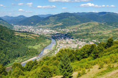 Ukraine Carpathians, Mizhhirya village in the valley of mountains, beautiful landscape from Makovytsya mountain.