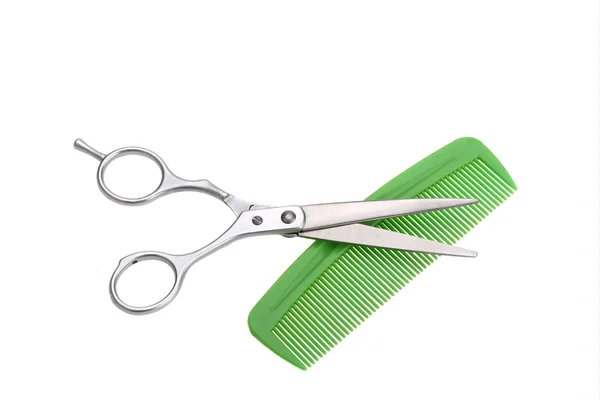 Scissors for cutting and green plastic comb — Stock Photo, Image