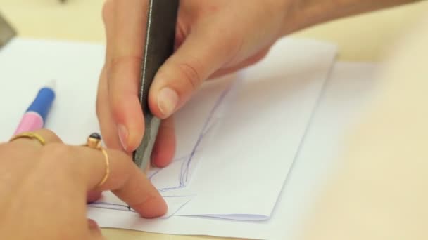 Woman cutting the pattern from the paper — Stock Video