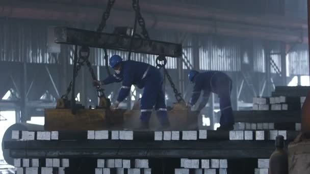 Workers transfer steel blocks — Stock Video