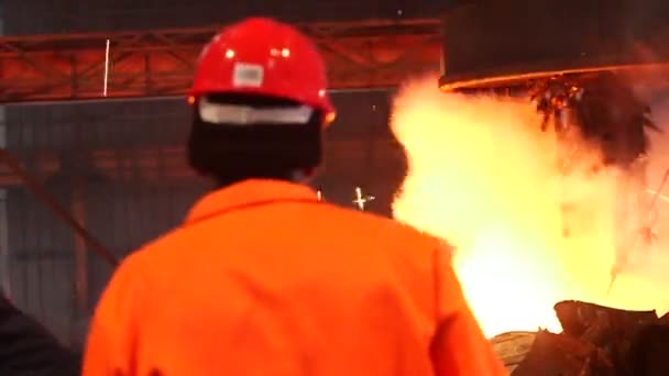 Worker controlling smelting iron in furnace — Stock Video