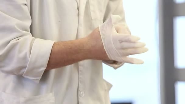 Doctor puts on his surgical gloves — Stock Video