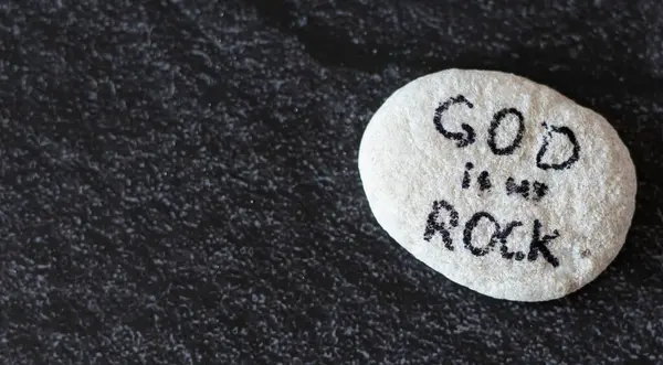 God Jesus Christ is my Rock and salvation. Handwritten Bible quote on stone. Christian biblical concept of hope, love, faith, trust. Copy space for text.